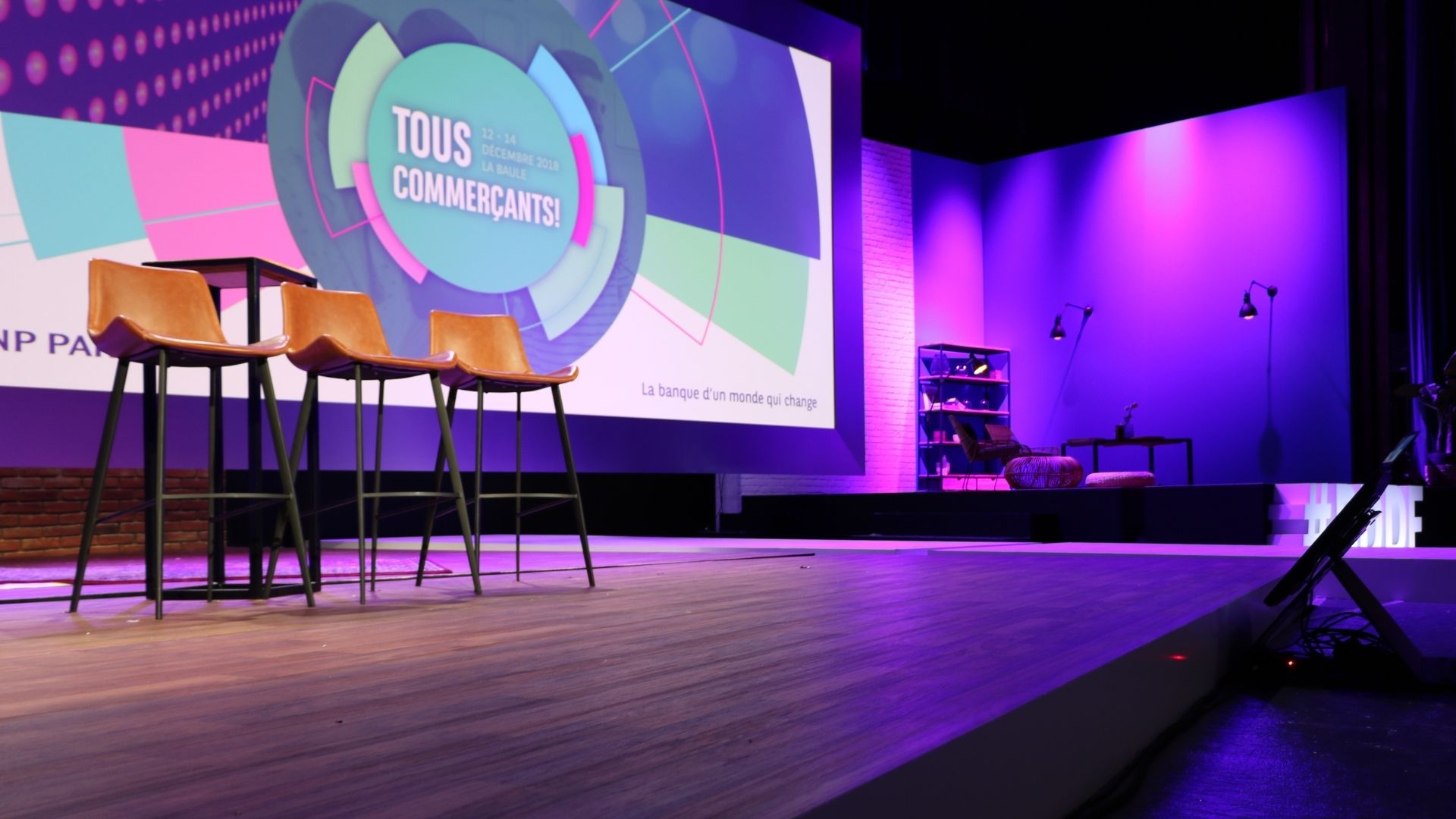 photo d'une scène de conférence au sein du Palais es Congrès de la Baule, écran avec projection et tabouret en attente des conférenciers